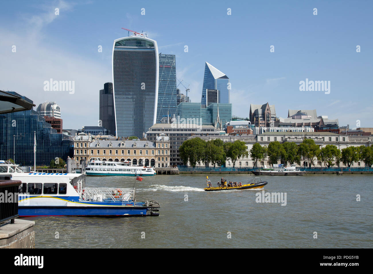 City of London, including Walkie Talkie, Scalpel and Old Billingsgate, from Southbank across River Thames with ferries and Thames Rib Experience boat Stock Photo