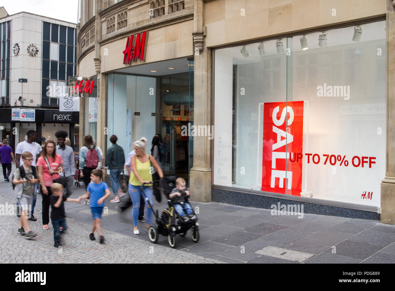 H&M Discount Sale, Shop & Shoppers, Fashion Stores with summer collection  window displays in Sheffield, UK Stock Photo - Alamy