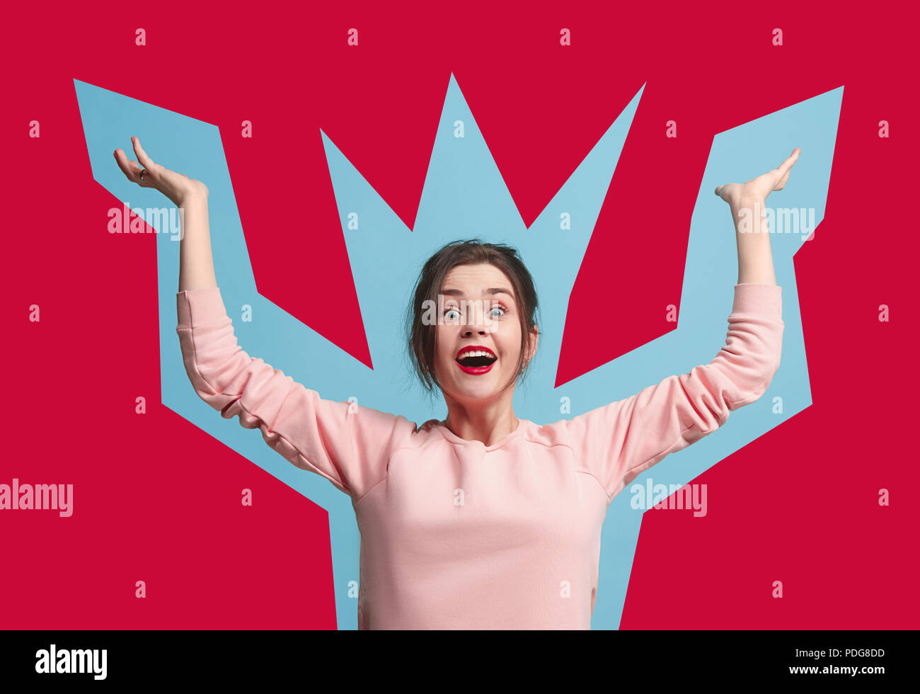 I won. Winning success happy woman celebrating being a winner. Dynamic image of caucasian female model on blue studio background. Victory, delight concept. Human facial emotions concept. Trendy colors Stock Photo
