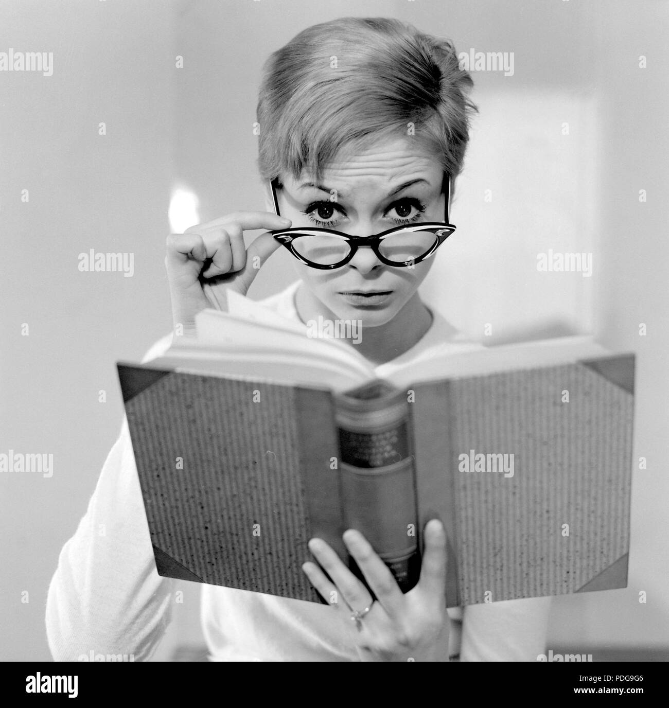 1960s glasses. A young woman in glasses and bows January 1961. Models name Monica Flodqvist Stock Photo