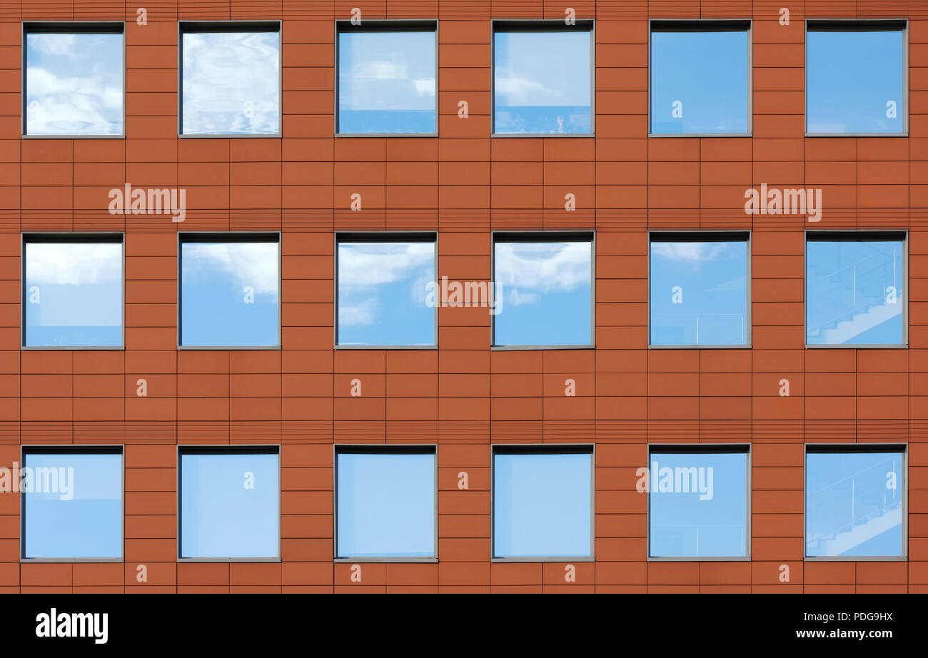 Minimalist facade of modern office building with square Windows. Finish is  a dark red color. The details of the architecture of the urban landscape  Stock Photo - Alamy, image size:1300x922