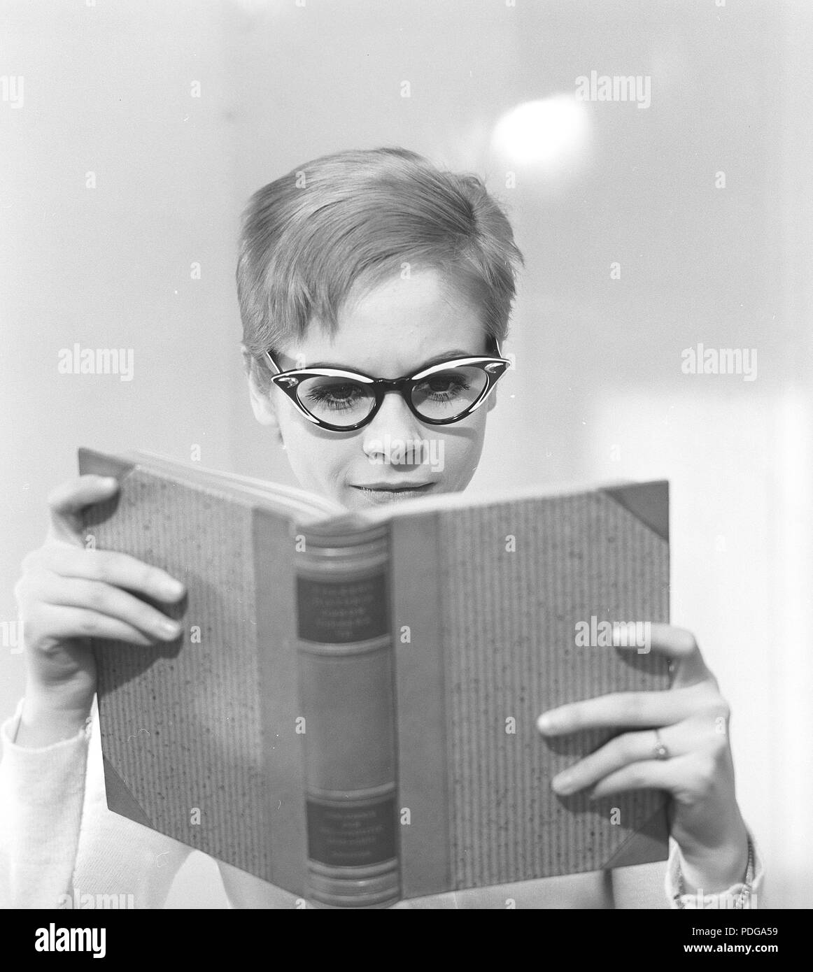 1960s glasses. A young woman in glasses and bows January 1961. Models name Monica Flodqvist Stock Photo