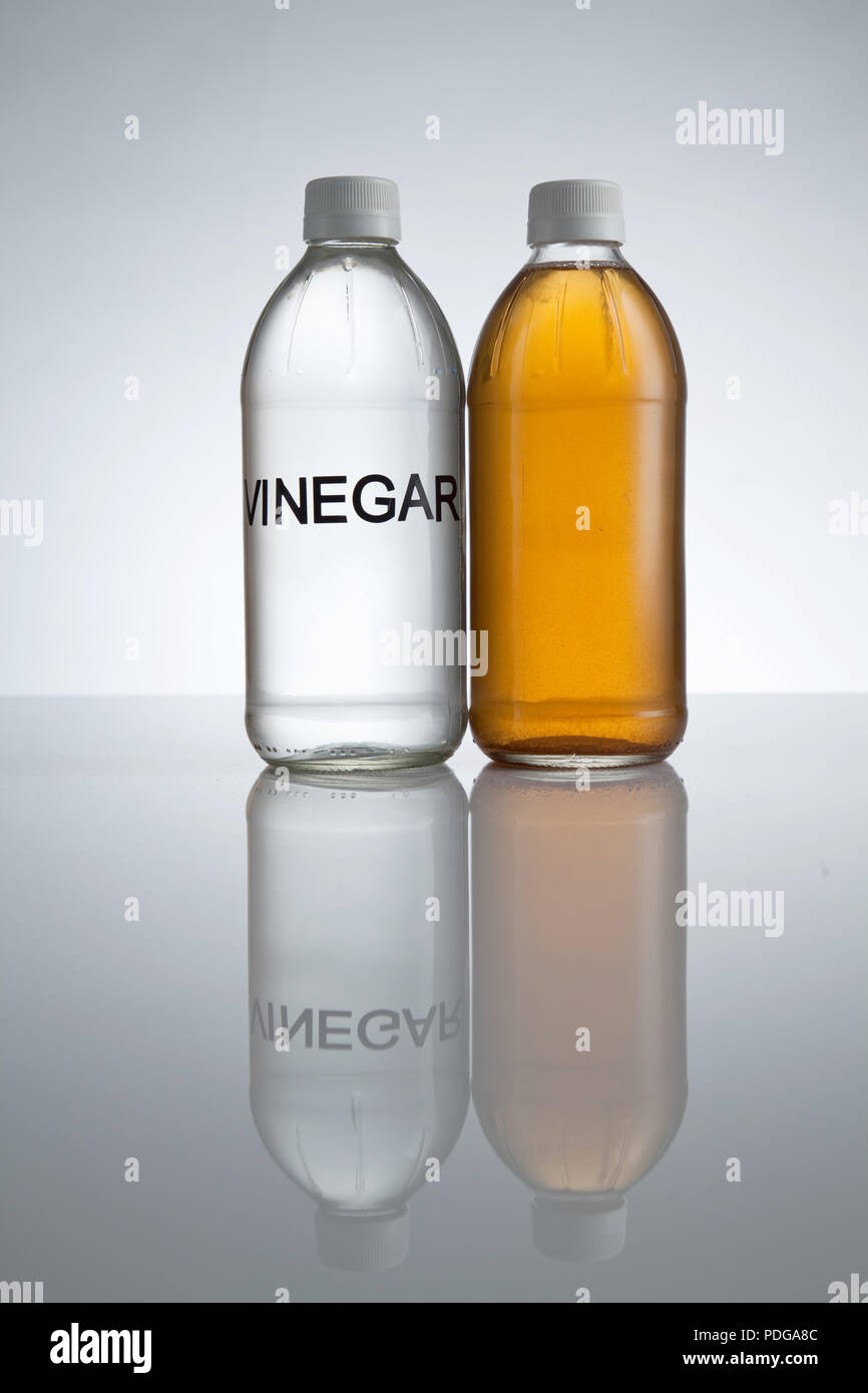 white vinegar and apple cider vinegar on white background Stock Photo