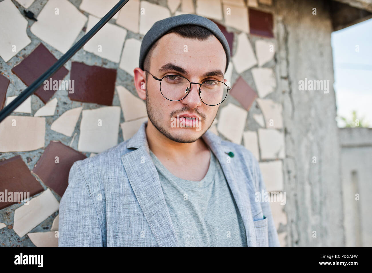Dreamer stylish macho man in gray suit, hat and glasses posed on the roof Stock Photo Alamy