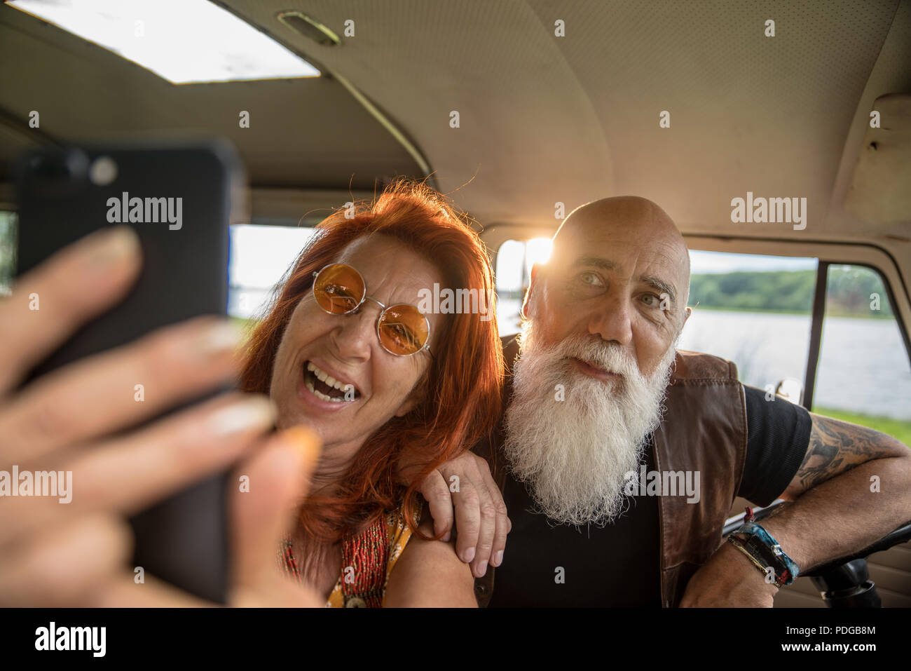 Portrait of an old hipster couple doing a selfie with a phone  Stock Photo