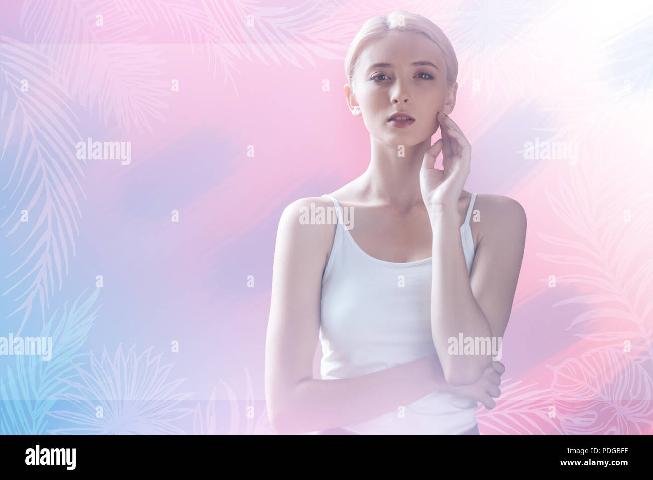 Young woman touching her face while visiting a beauty salon Stock Photo