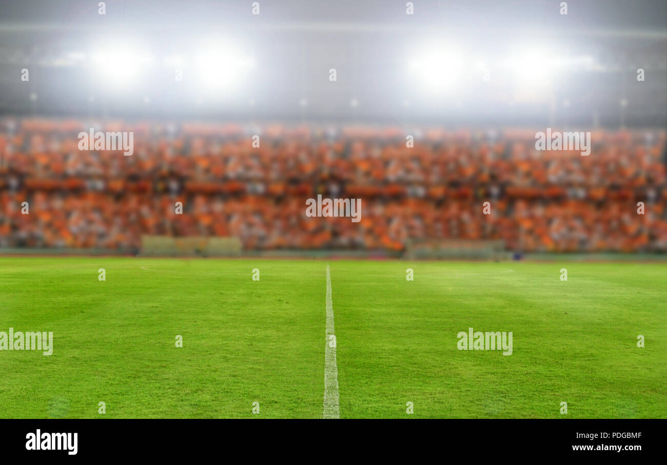blurry and soft focus of football stadium and arena soccer field championship win for background