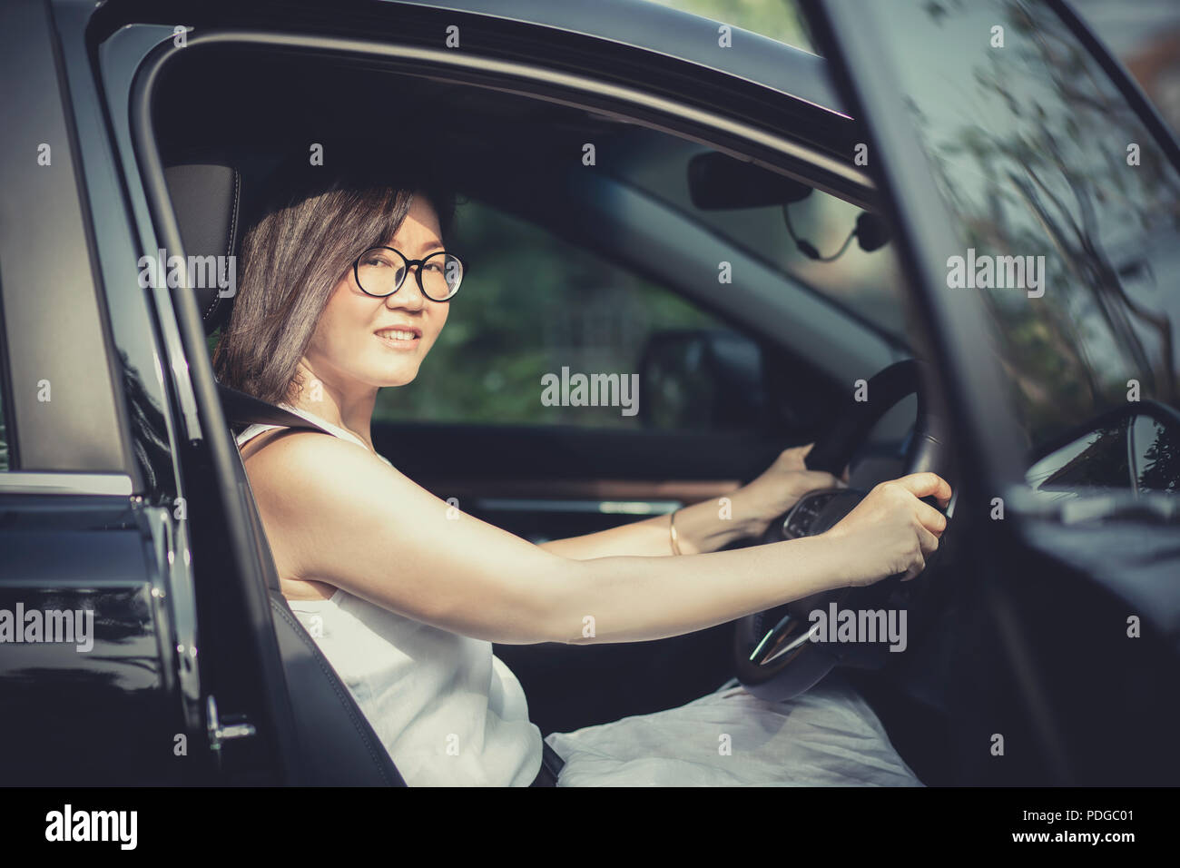 asian woman fasten car seat belt before take a driving Stock Photo