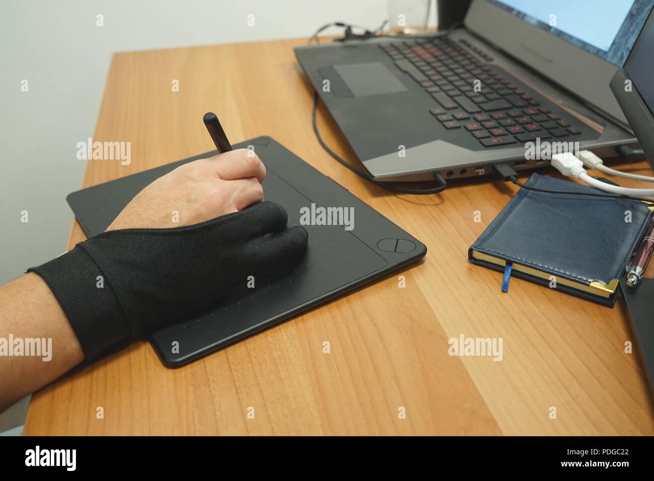 Man designer freelancer use graphics tablet with touch screen and pen ...