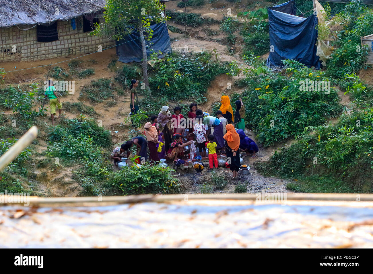 Rohingya refugees gather at a water pump at Balukhali Refugee Camp. Cox's Bazar, Bangladesh Stock Photo