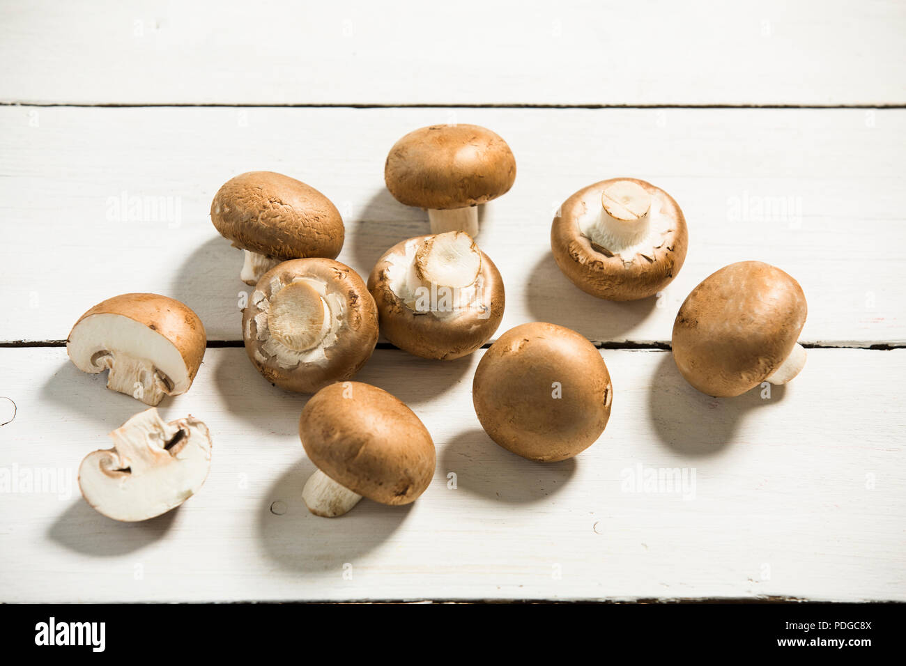 brown mushrooms on a white wooden plate Stock Photo