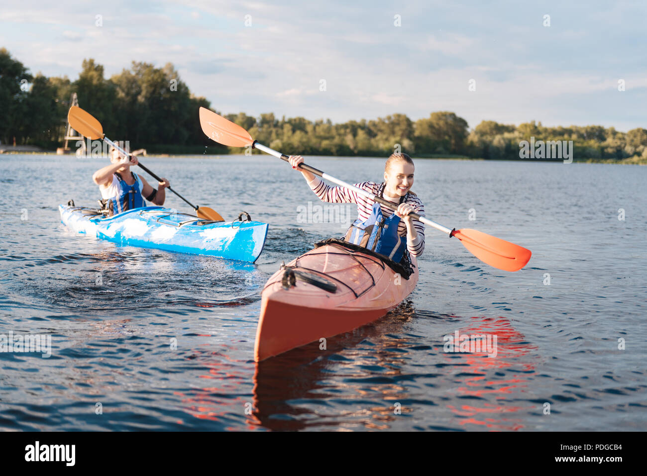 Happy woman laughing while having memorable river ride with boyfriend Stock Photo