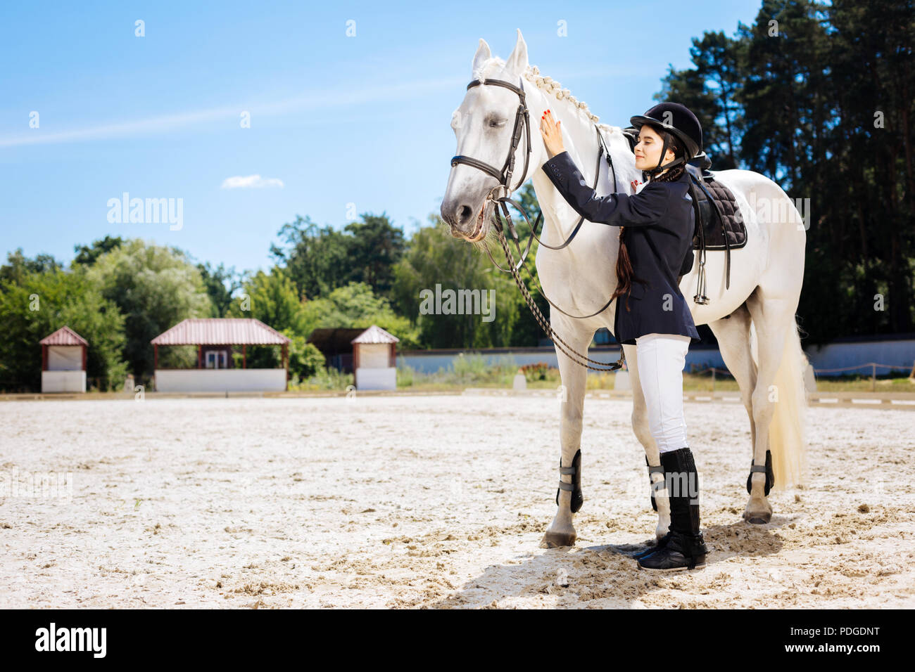 Female rider wearing white trousers and 