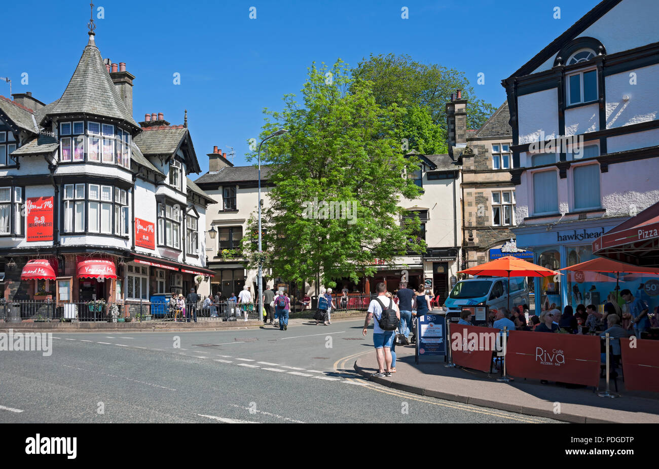 Tourists visitors in the town centre outdoor seating restaurants and bars summer Bowness on Windermere Cumbria England UK United Kingdom Great Britain Stock Photo