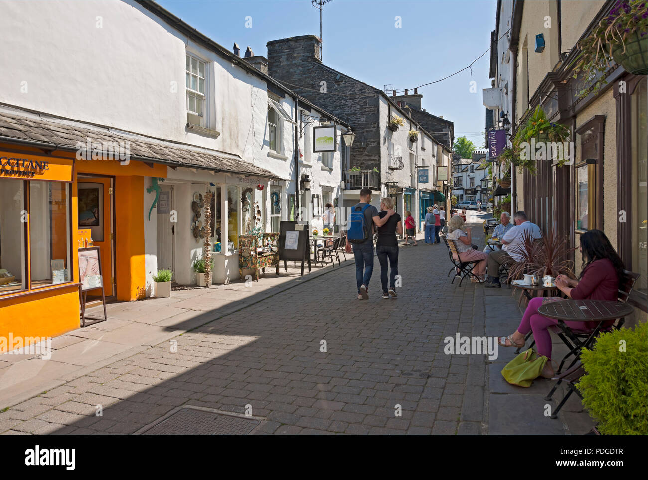 People tourists visitors and shops stores restaurants in the town