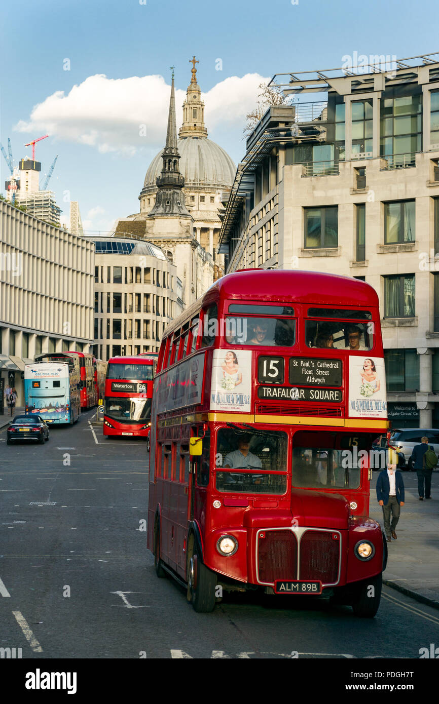 A London Heritage Route 15 AEC Routemaster red double-decker bus driving along Fleet Street with St. Pauls cathedral in background, London, UK Stock Photo