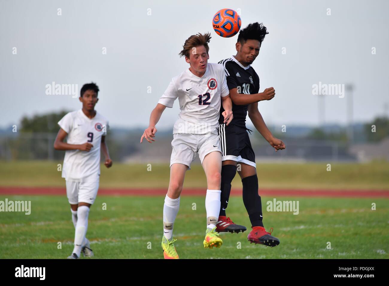 Player making contact while battling to execute a header. USA. Stock Photo