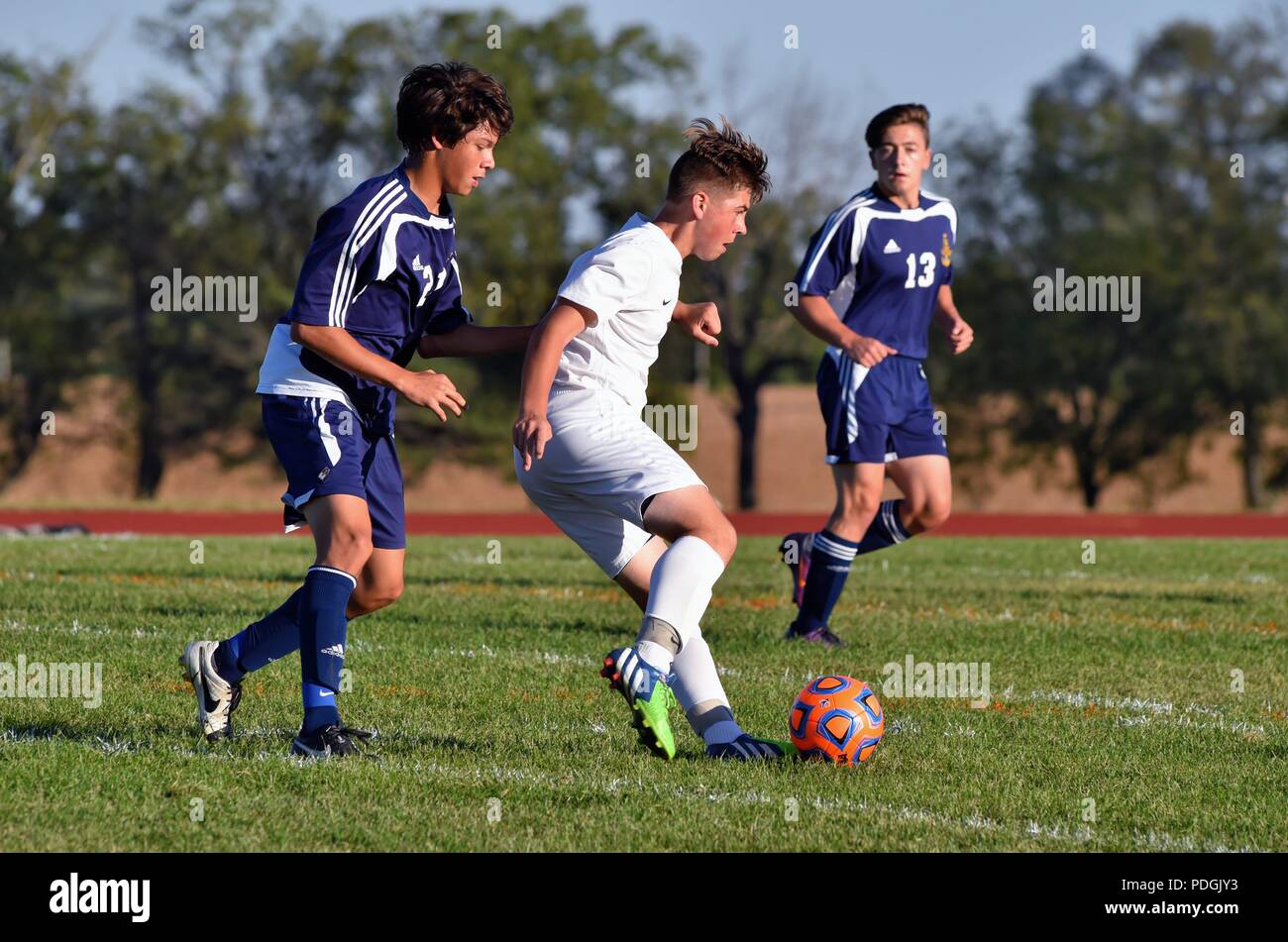 Player in front of an opponent looking to maintain control of the ball while dribbling. USA. Stock Photo