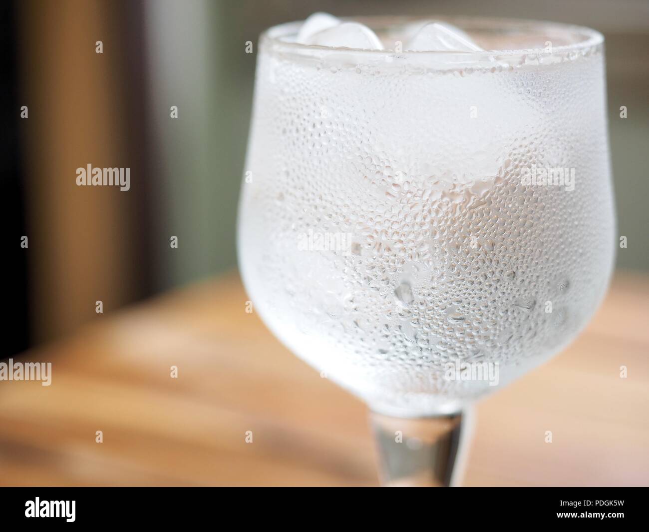Ice water in a glass cup Stock Photo - Alamy