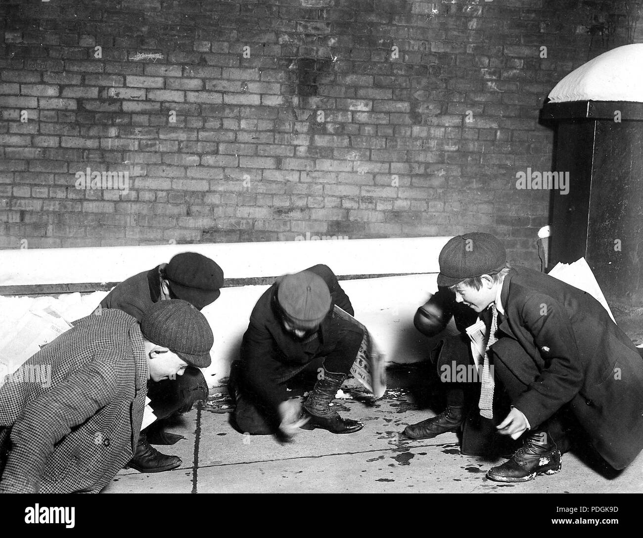 A group of Newsies playing craps in the jail alley at 10 P.M. Albany, N.Y., February 1910 Stock Photo