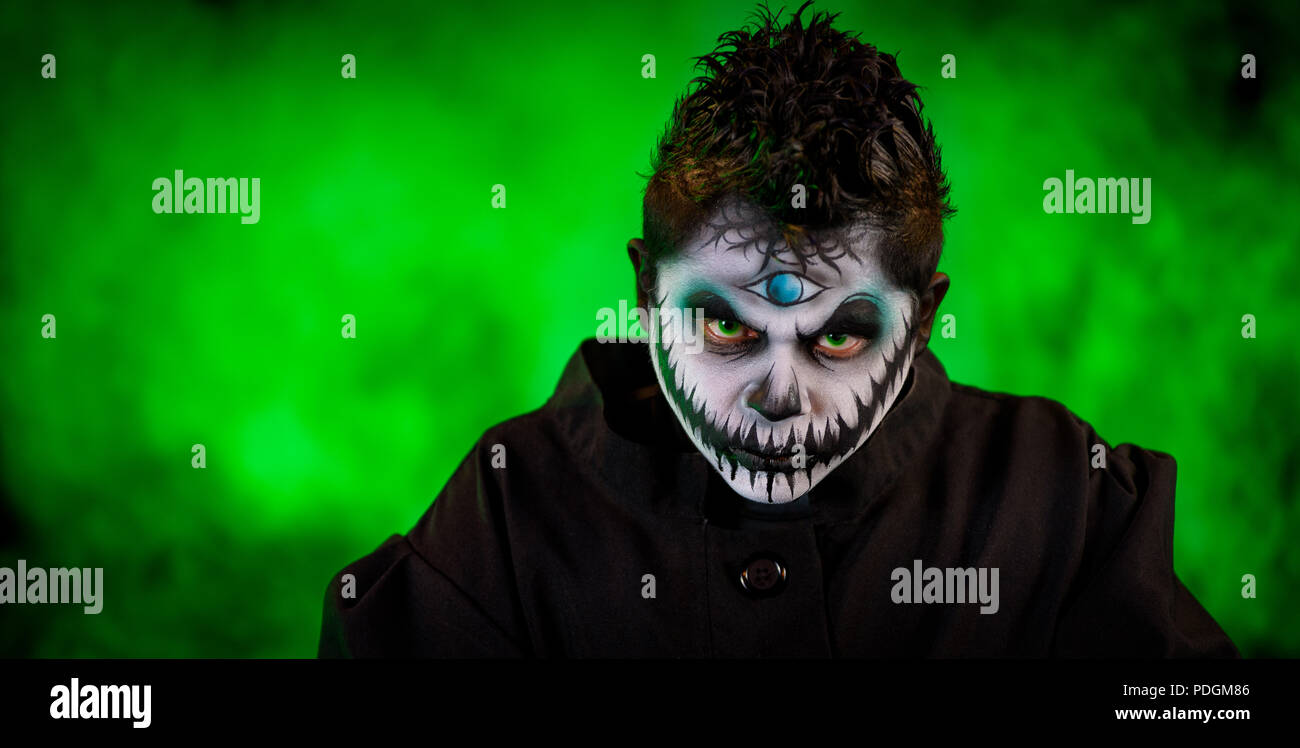 A male latino model with a modern and horror style approach to the Mayan God of the underworld, Xibalba. Shot against a black background with theatric Stock Photo