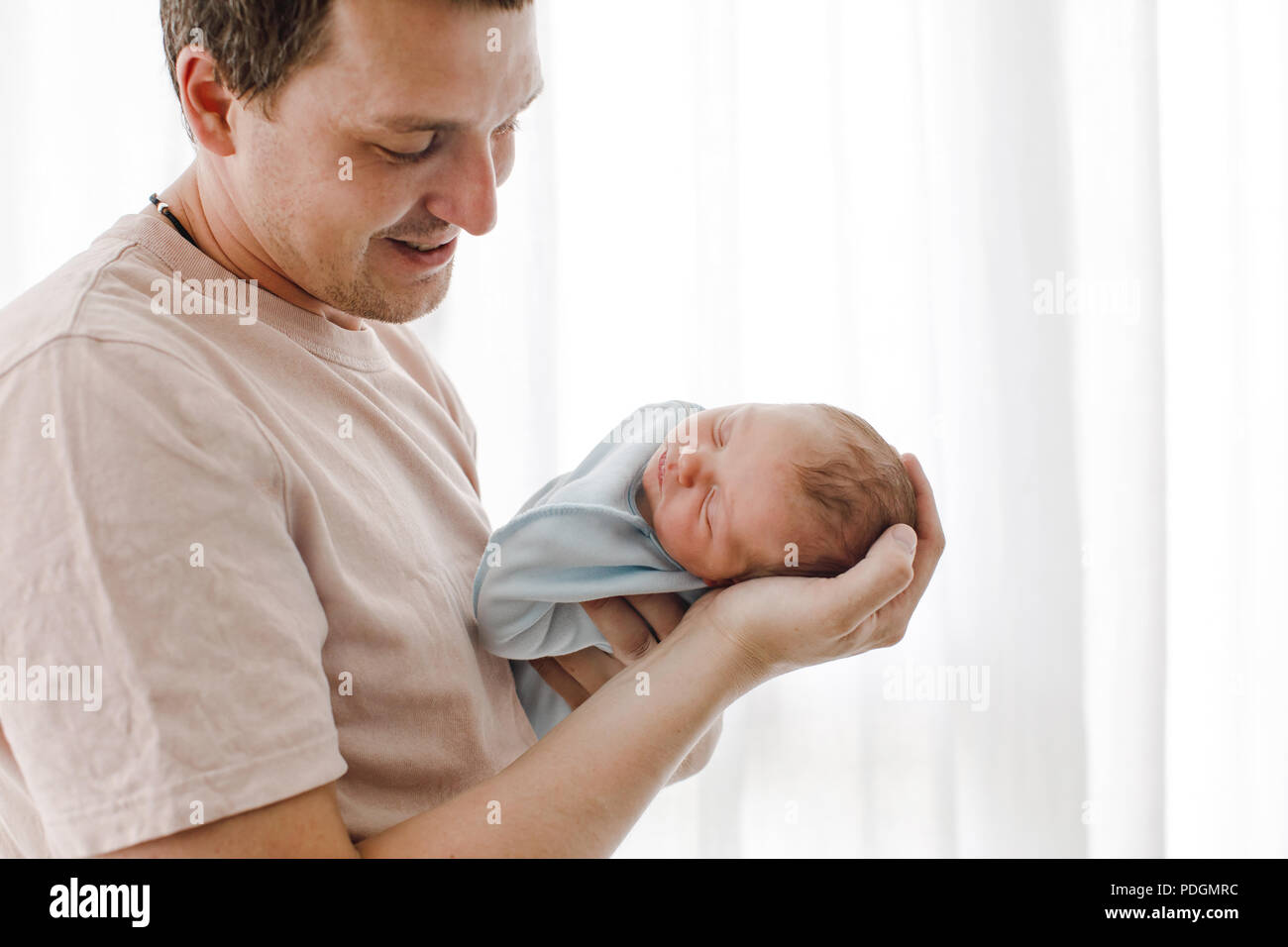 Father holding his newborn baby daughter Stock Photo
