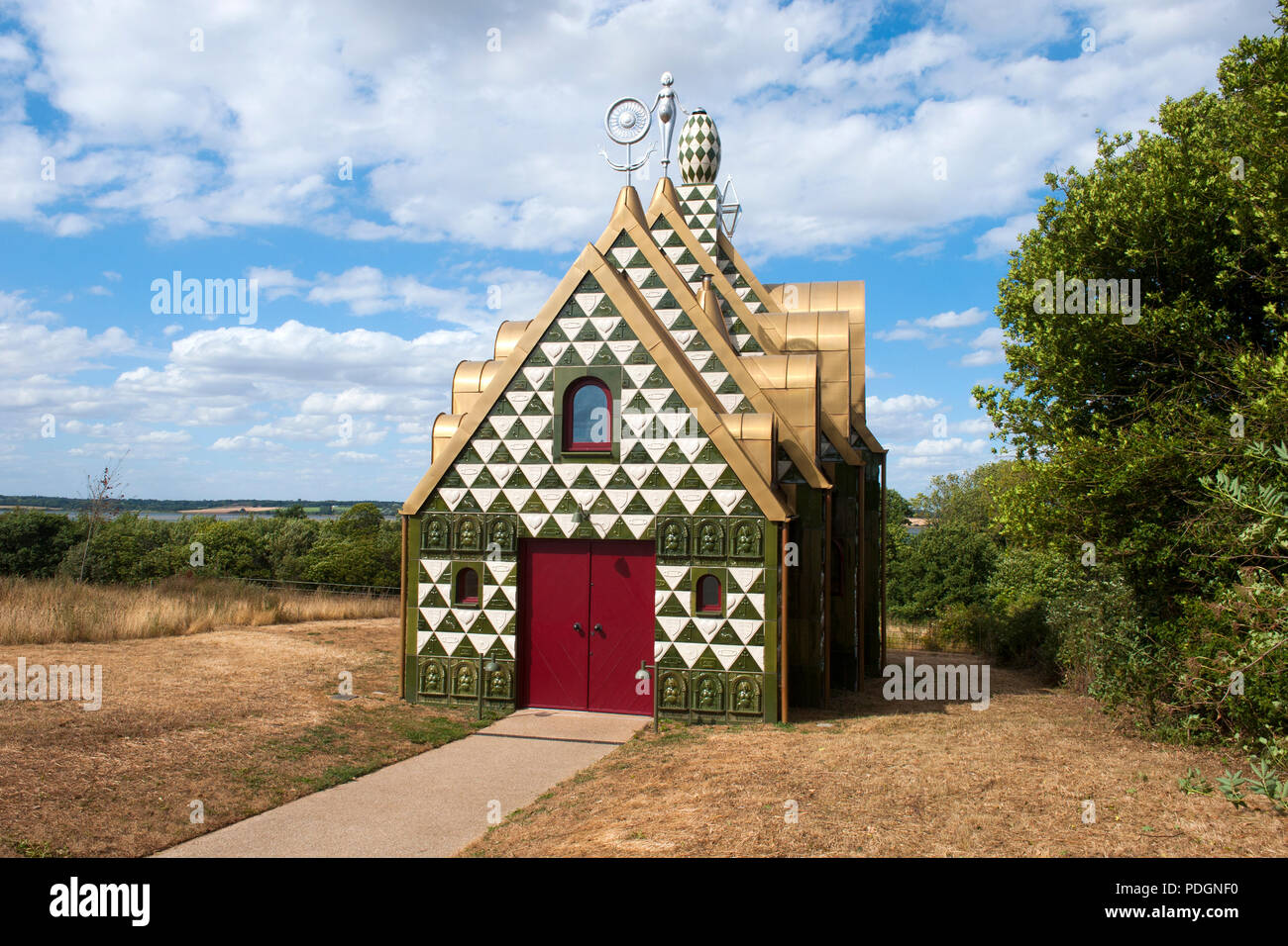 A House for Essex, Julie's House by Grayson Perry. In 2015 a conceptual holiday home was created by the artist Grayson Perry, working with FAT, and commissioned by the charity Living Architecture. It is known as 'Julie’s House' or 'A House for Essex', in homage to the 'single mums in Dagenham, hairdressers in Colchester, and the landscape and history of Essex'. The house is highly decorated incorporating rooftop ornaments, and overlooks the River Stour in Wrabness, Essex Stock Photo