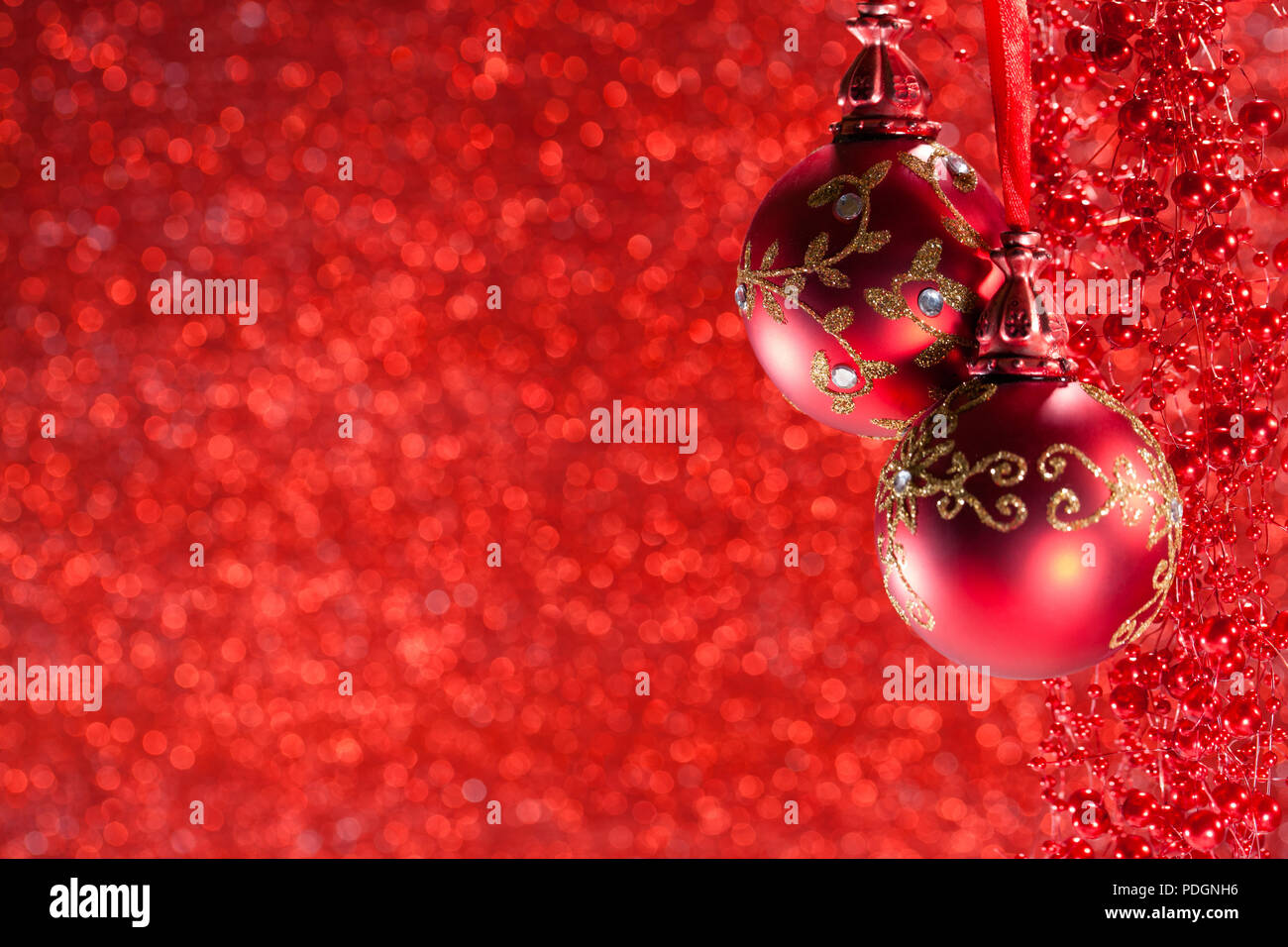 winter Christmas picture with a red ball and Christmas tree tops, over blue bokeh background. New Year's Tinsel. Christmas blank background. Stock Photo