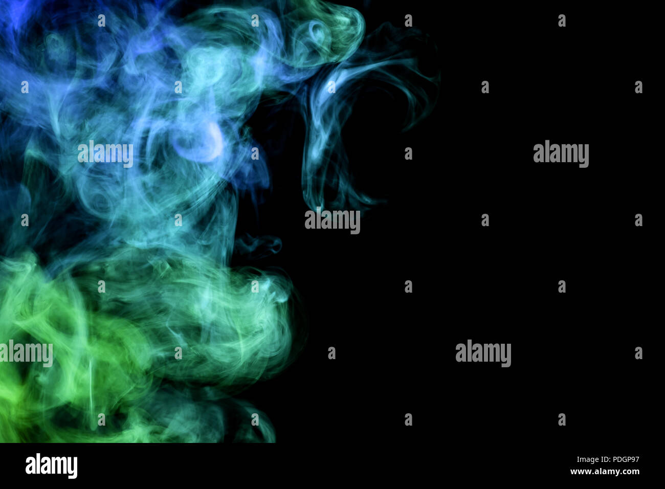 Green and blue smoke on black background Stock Photo - Alamy