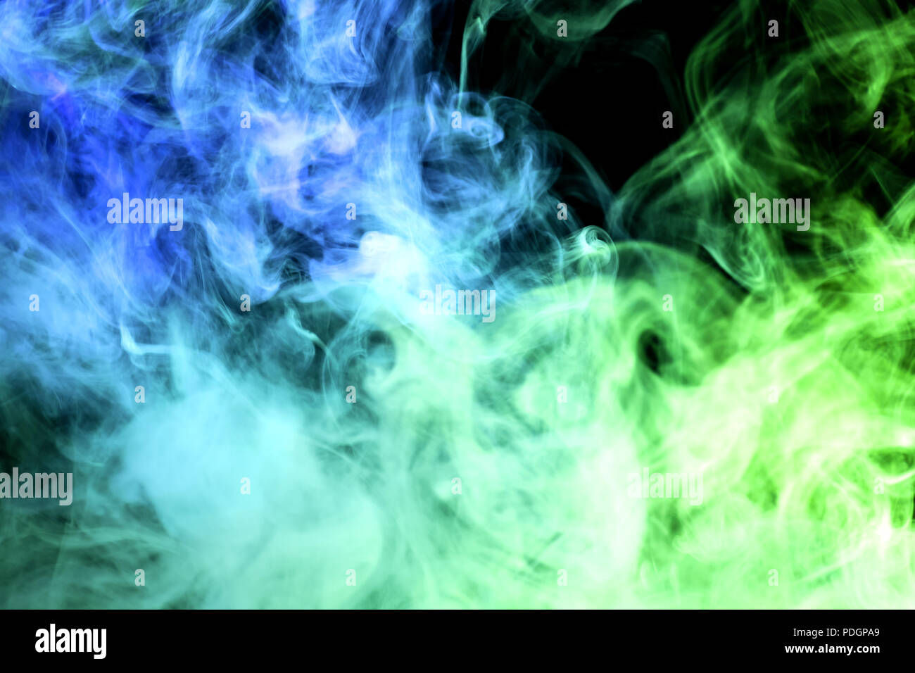 Green and blue smoke on black background Stock Photo - Alamy