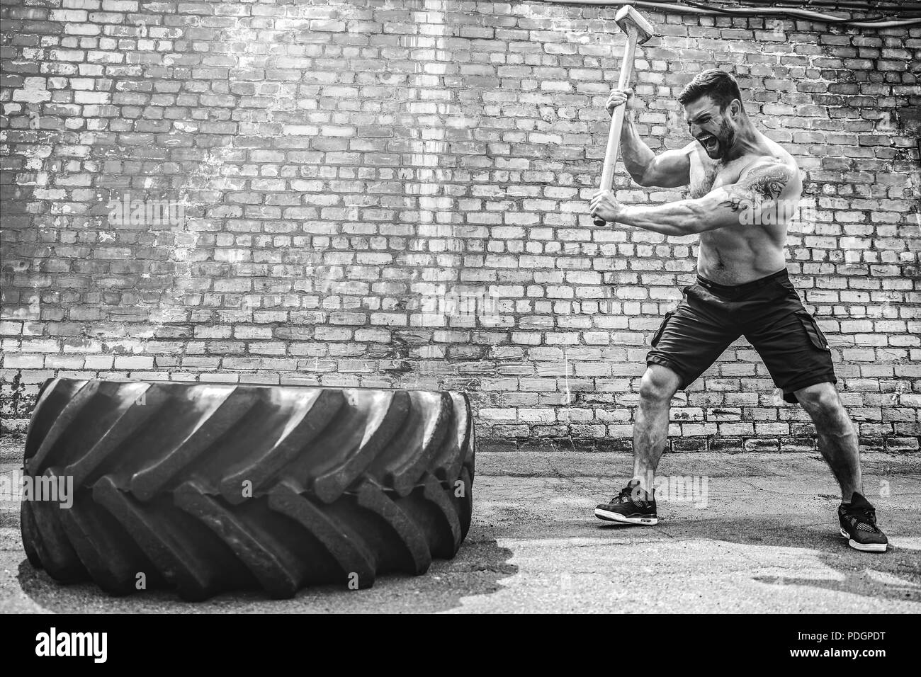 Sport Fitness Man Hitting Wheel Tire With Hammer Sledge Crossfit ...