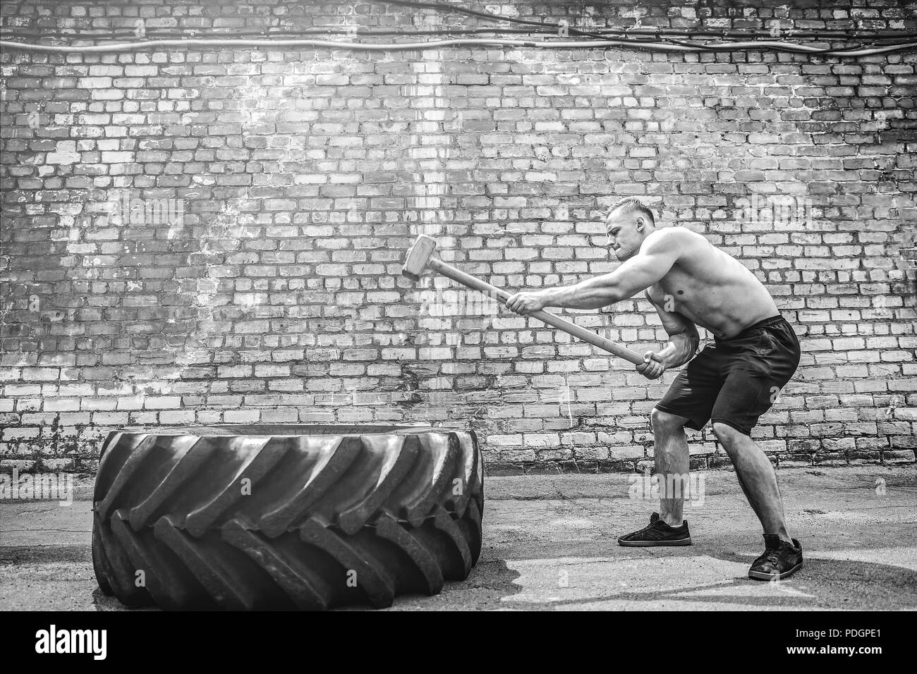 Crossfit sledge hammer man workout hires stock photography and images