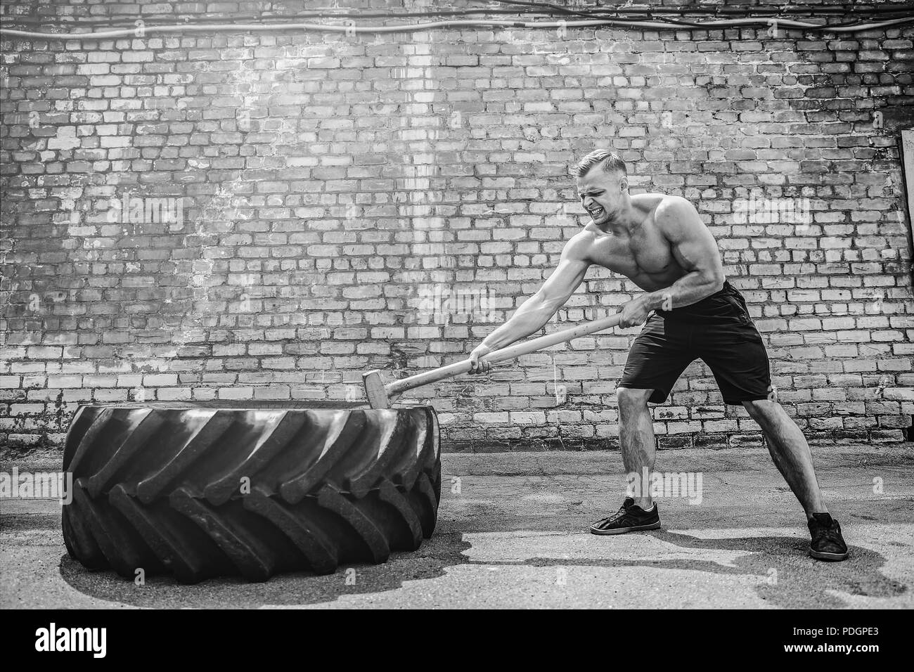 Crossfit sledge hammer man workout hires stock photography and images