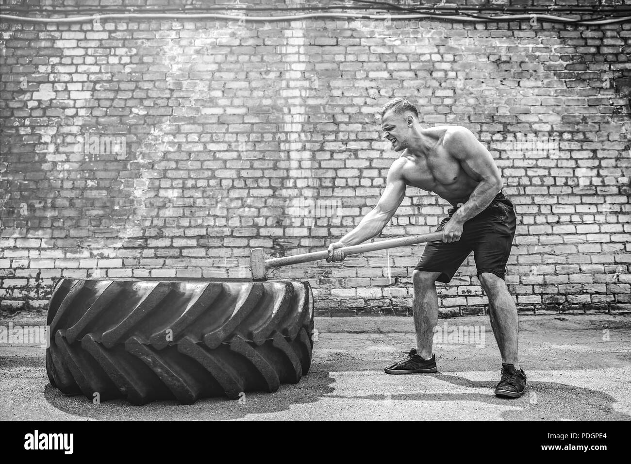 Crossfit sledge hammer man workout hires stock photography and images