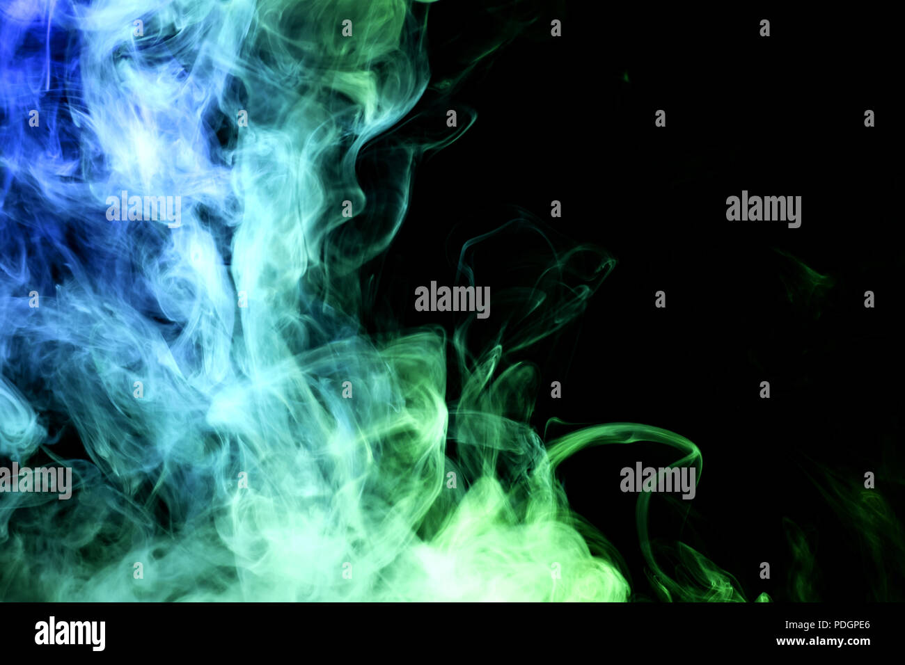 Green and blue smoke on black background Stock Photo - Alamy
