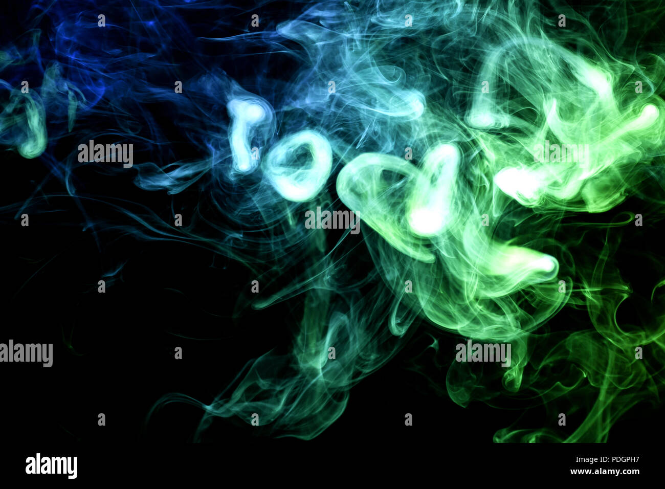 Thick blue and green smoke on a black isolated background. Background ...
