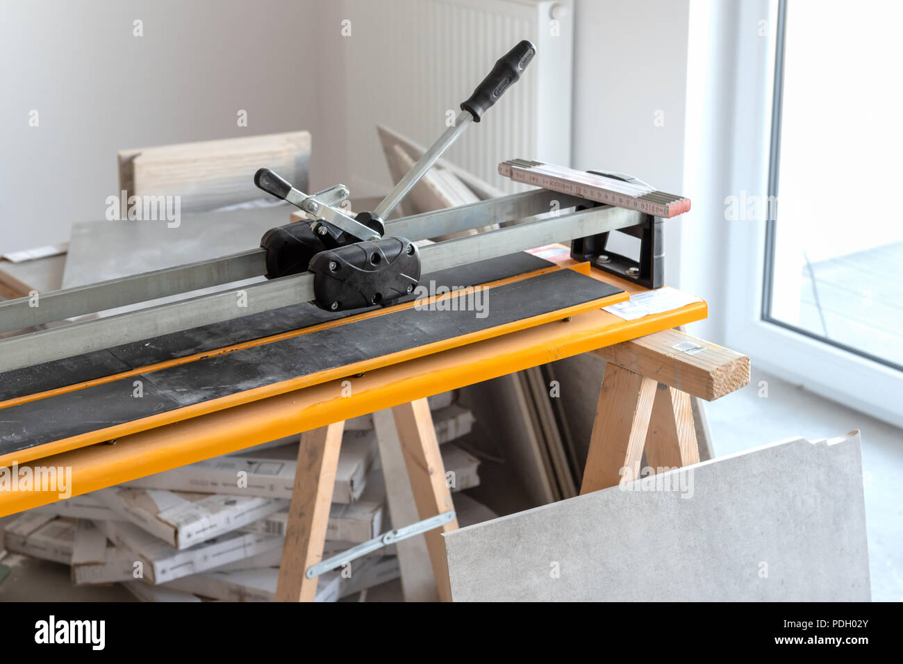 Cutter machine for ceramic tiles. A flat during renovation. Stock Photo