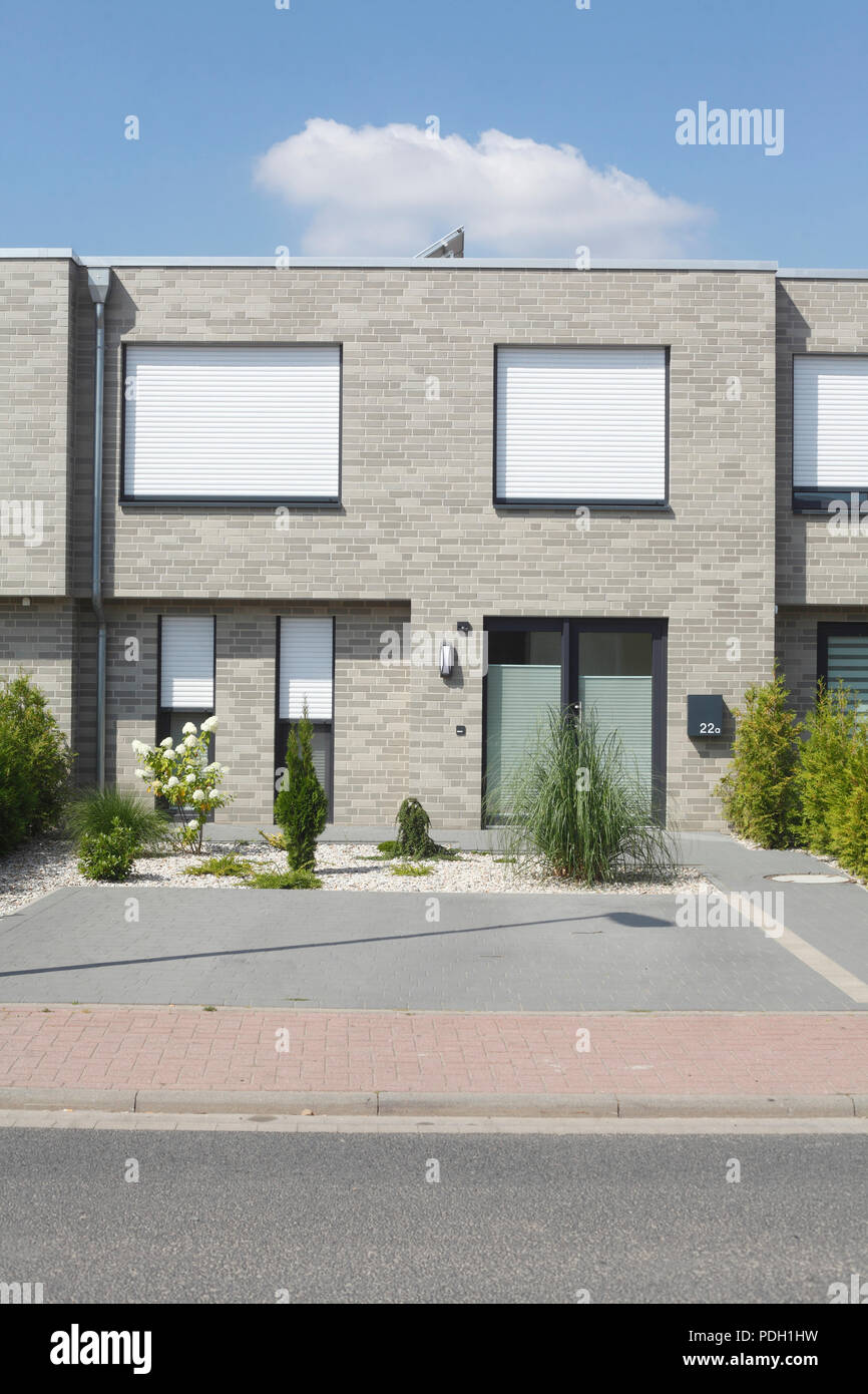 Modern gray detached house, white windows with blinds pulled down Stock ...