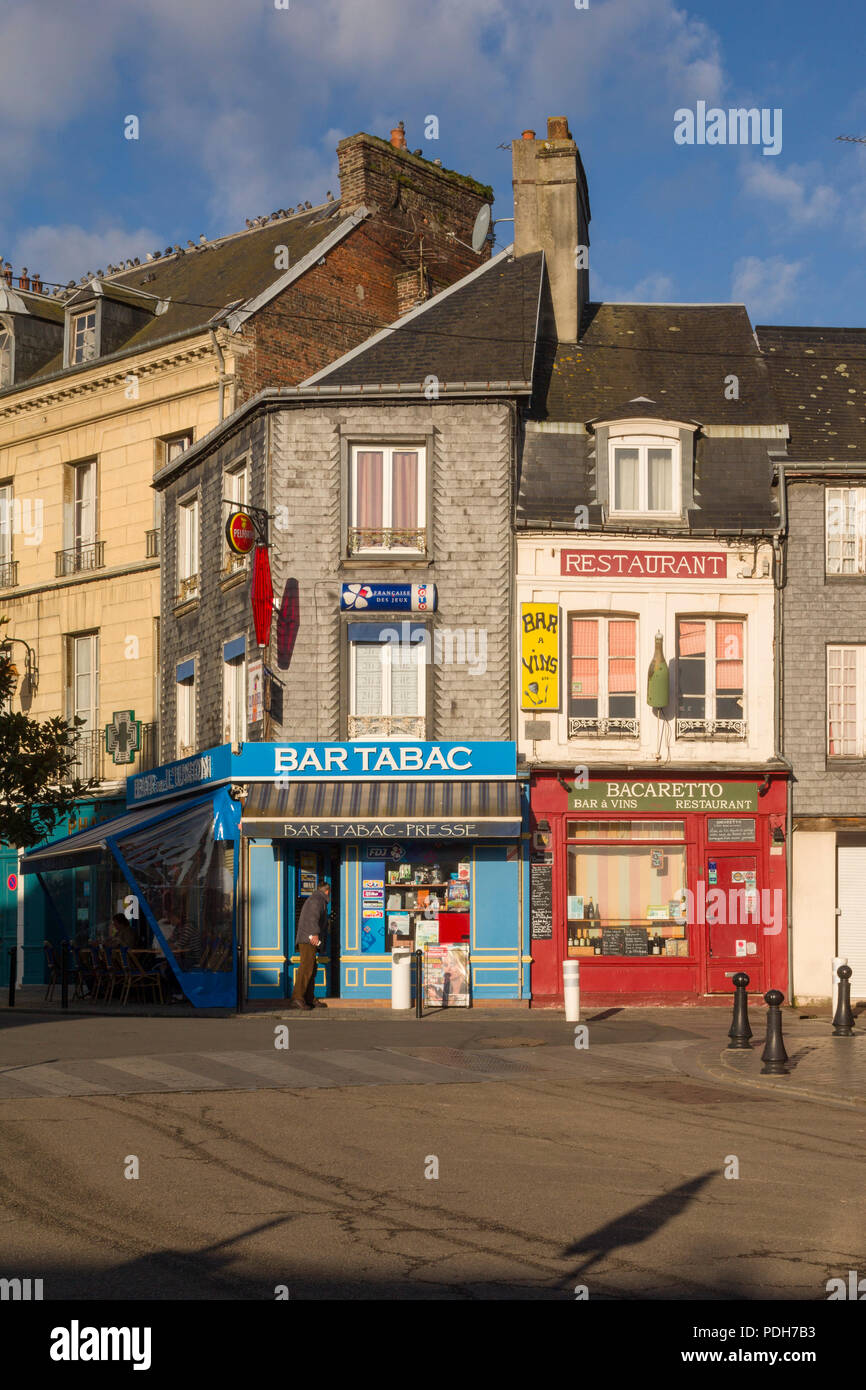 Colourful facades of a restaurant and tobacconist or Bar Tabac in Honfleur, Normandy, France Stock Photo