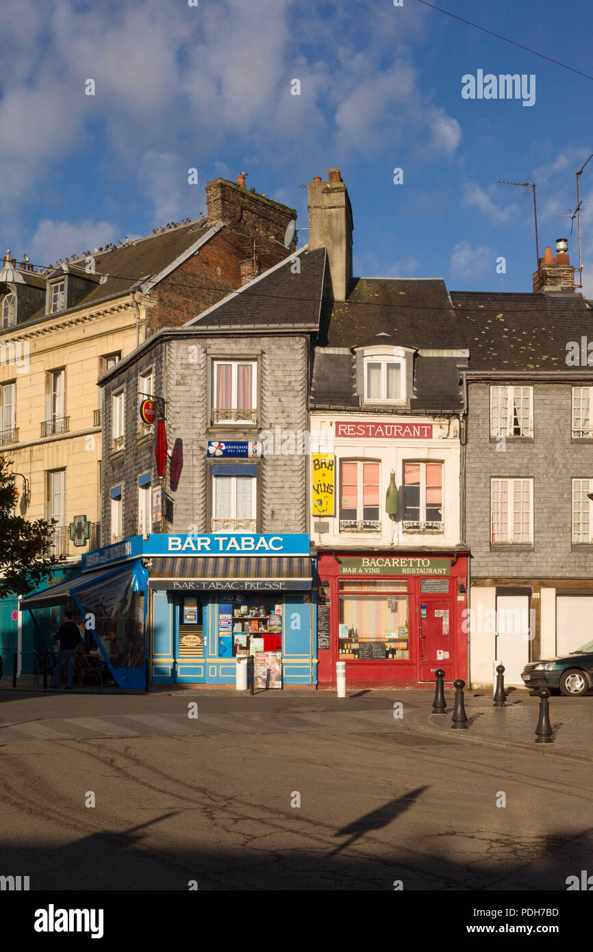 Colourful facades of a restaurant and tobacconist or Bar Tabac in Honfleur, Normandy, France Stock Photo