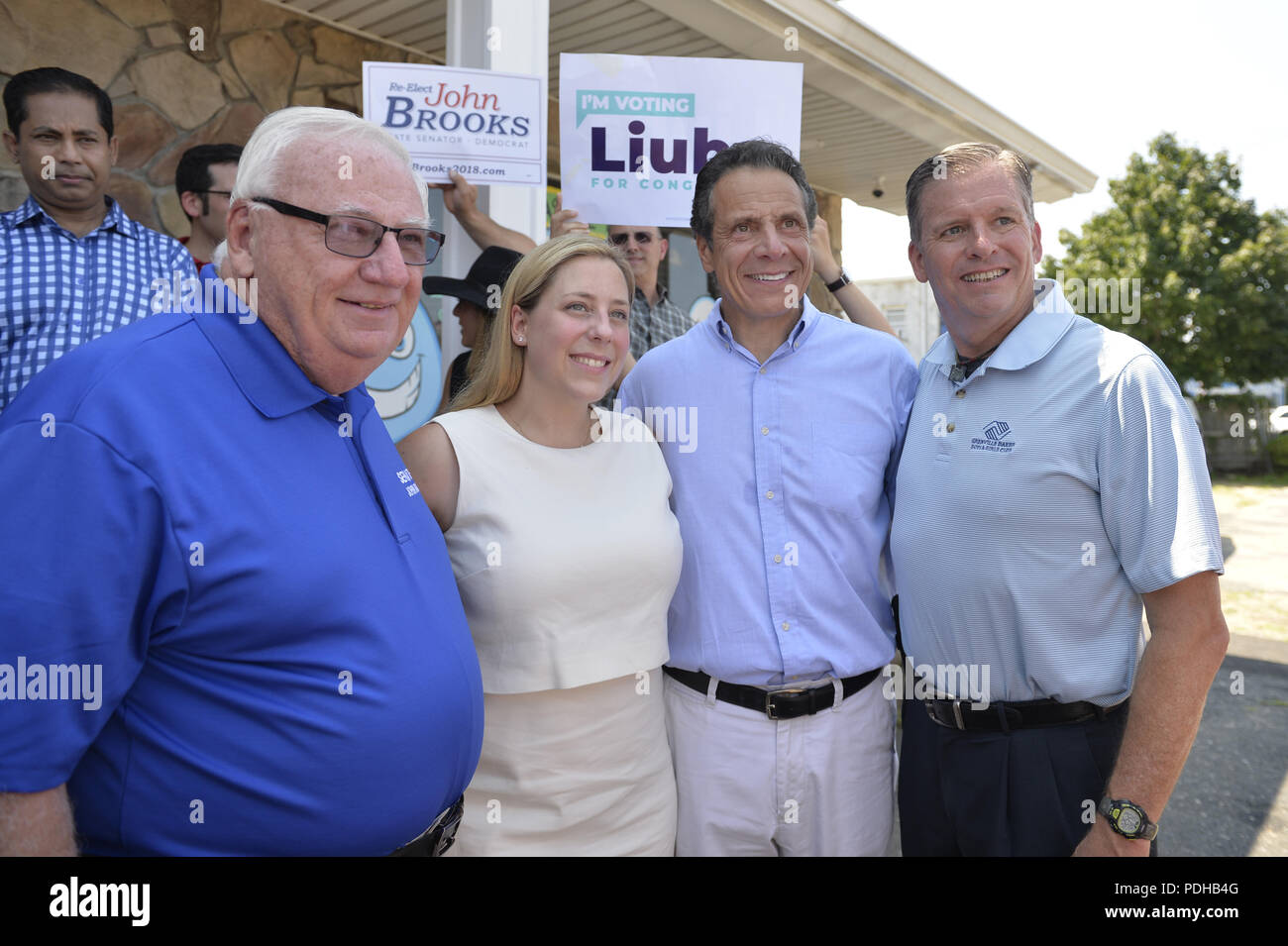 Massapequa, New York, USA. 5th Aug, 2018. L-R, NY Senator JOHN BROOKS; LIUBA GRECHEN SHIRLEY, Congressional candidate for NY 2nd District; Governor ANDREW CUOMO; and DAVID GUGERY, the Democratic Commissioner of Nassau County Board of Elections; pose during opening of joint campaign office for the 2 Long Islander candidates, aiming for a Democratic Blue Wave in November midterm elections. Credit: Ann Parry/ZUMA Wire/Alamy Live News Stock Photo