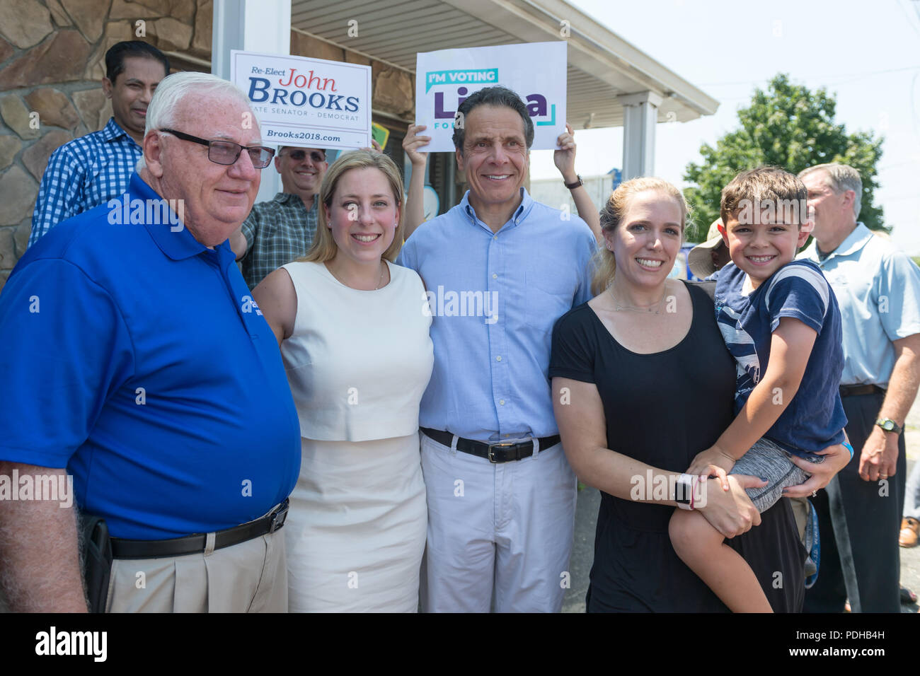 Massapequa, New York, USA. 5th Aug, 2018. L-R, NY Senator JOHN BROOKS; LIUBA GRECHEN SHIRLEY, Congressional candidate for NY 2nd District; and Governor ANDREW CUOMO; pose with a supporter holding her young son during opening of joint campaign office for the 2 Long Islander candidates, aiming for a Democratic Blue Wave in November midterm elections. Credit: Ann Parry/ZUMA Wire/Alamy Live News Stock Photo