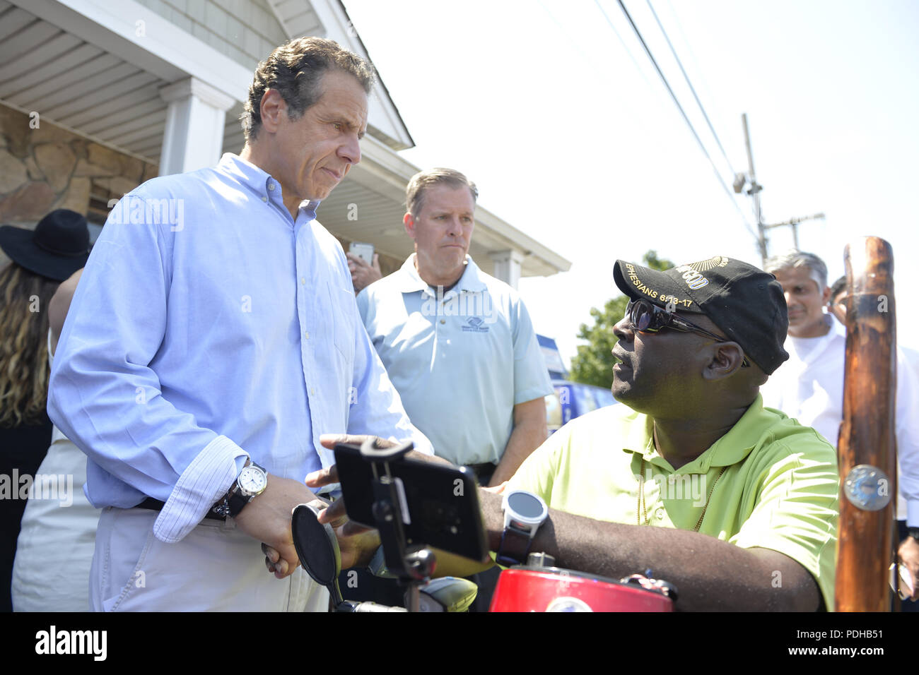 Massapequa, New York, USA. 5th Aug, 2018. Gov. ANDREW CUOMO, running for re-election, speaks with disabled man asking for government action helping the handicapped. The governor was a special guest at opening of joint campaign office for Grechen Shirley and NY Sen. J. Brooks, aiming for a Democratic Blue Wave in November midterm elections. Credit: Ann Parry/ZUMA Wire/Alamy Live News Stock Photo
