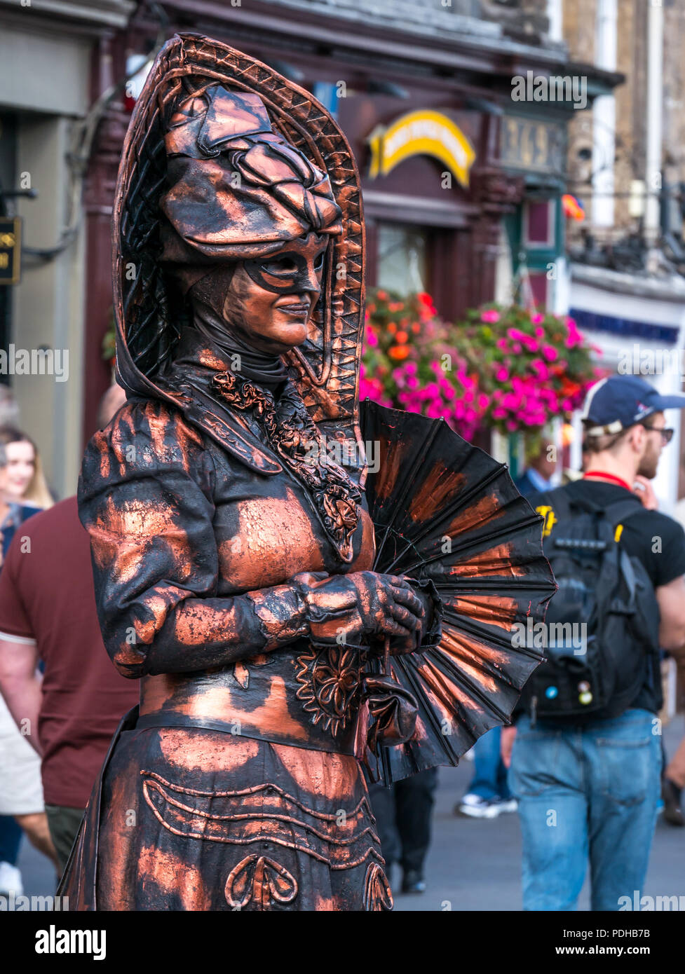 Edinburgh, Scotland, UK. 9th August 2018. Edinburgh Fringe Festival, Royal Mile, Edinburgh, Scotland, United Kingdom. On a sunny festival day the Virgin Money sponsored street festival is packed with people and fringe performers. A woman street performer dressed in an elaborate fantasy costume Stock Photo