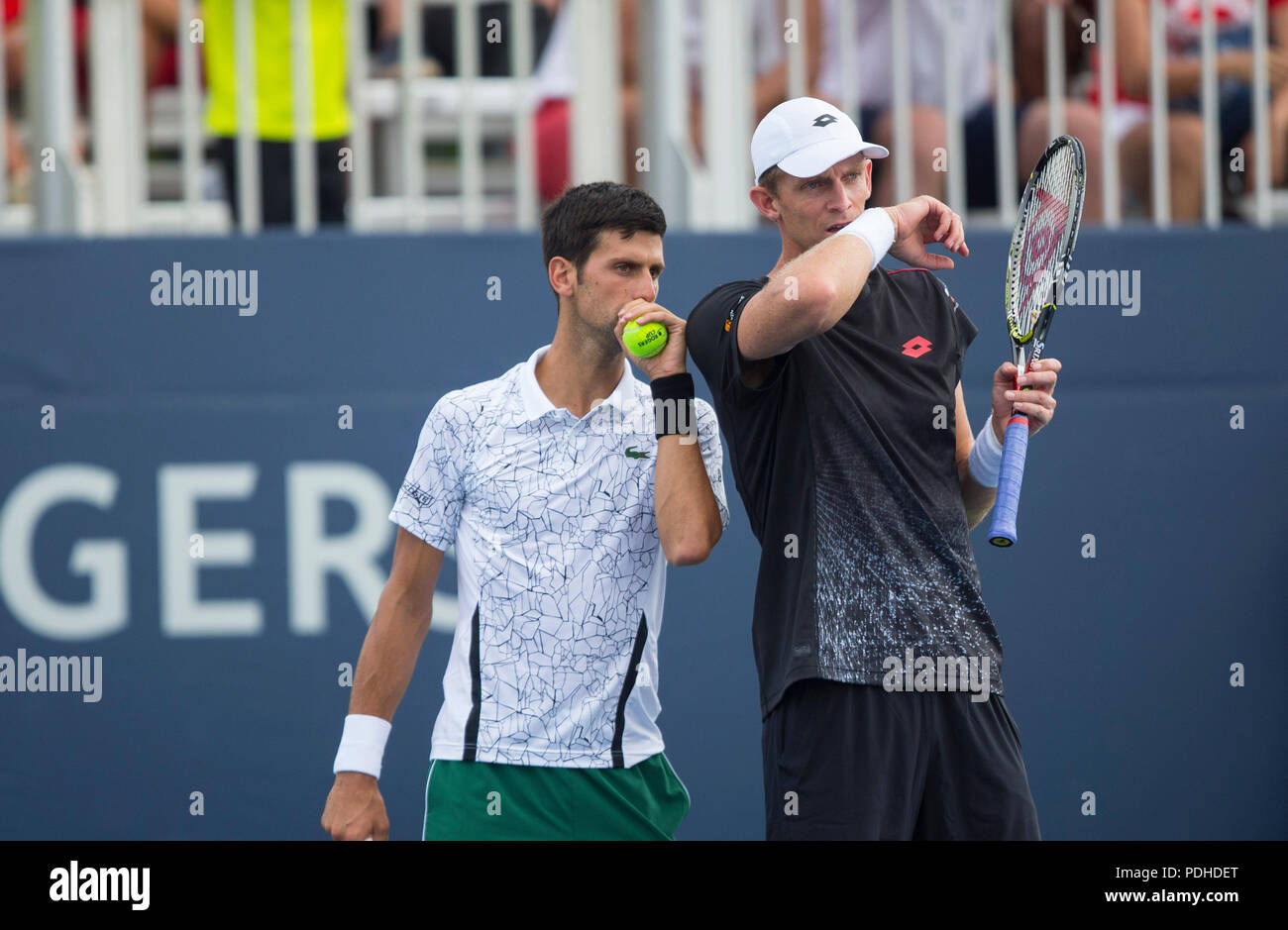 toronto-canada-9th-aug-2018-novak-djokovic-l-of-serbia-and-kevin-anderson-of-south-africa-react-during-the-second-round-of-mens-doubles-match-against-pierre-hugues-herbertnicolas-mahut-of-france-at-the-2018-rogers-cup-in-toronto-canada-aug-9-2018-novak-djokovickevin-anderson-won-2-1-credit-zou-zhengxinhuaalamy-live-news-PDHDET.jpg
