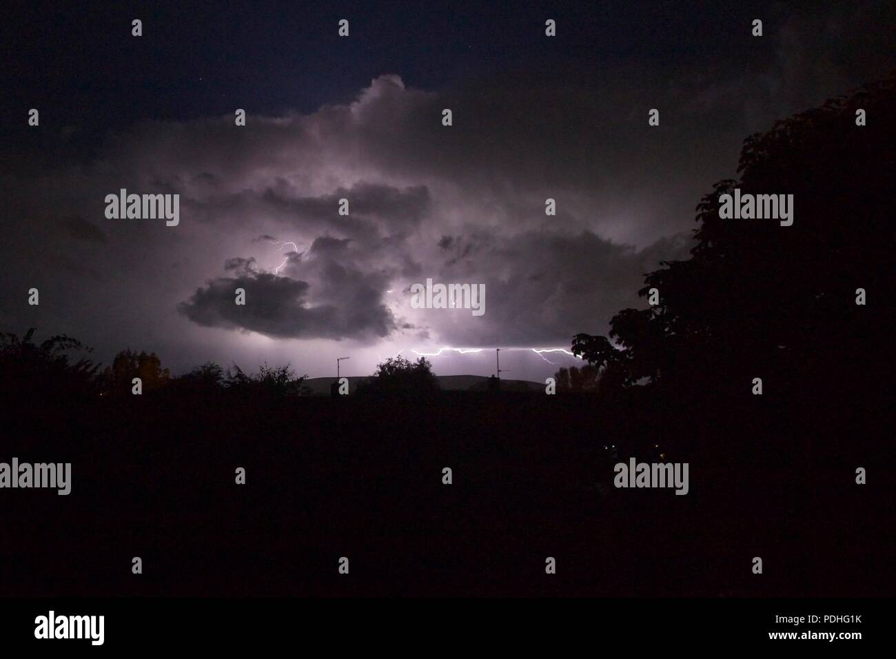 10th Aug 2018. UK weather.  Storm clouds overnight brought a lightning storm to parts of Sussex with fork lightning over houses in  East Sussex, UK. Credit: Ed Brown/Alamy Live News Stock Photo