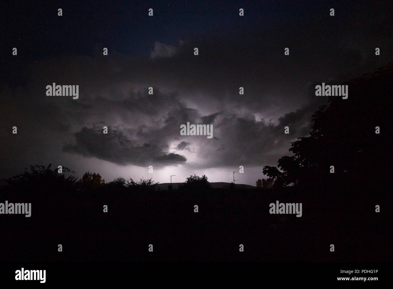 10th Aug 2018. UK weather.  Storm clouds overnight brought a lightning storm to parts of Sussex with fork lightning over houses in  East Sussex, UK. Credit: Ed Brown/Alamy Live News Stock Photo