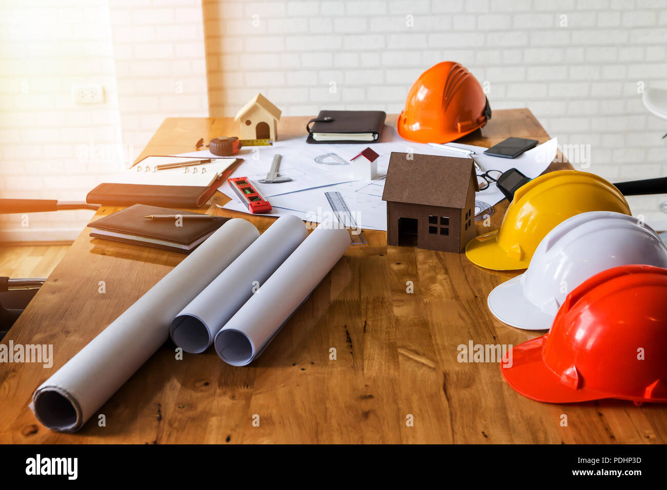 A architects house model with plan and blueprints Stock Photo