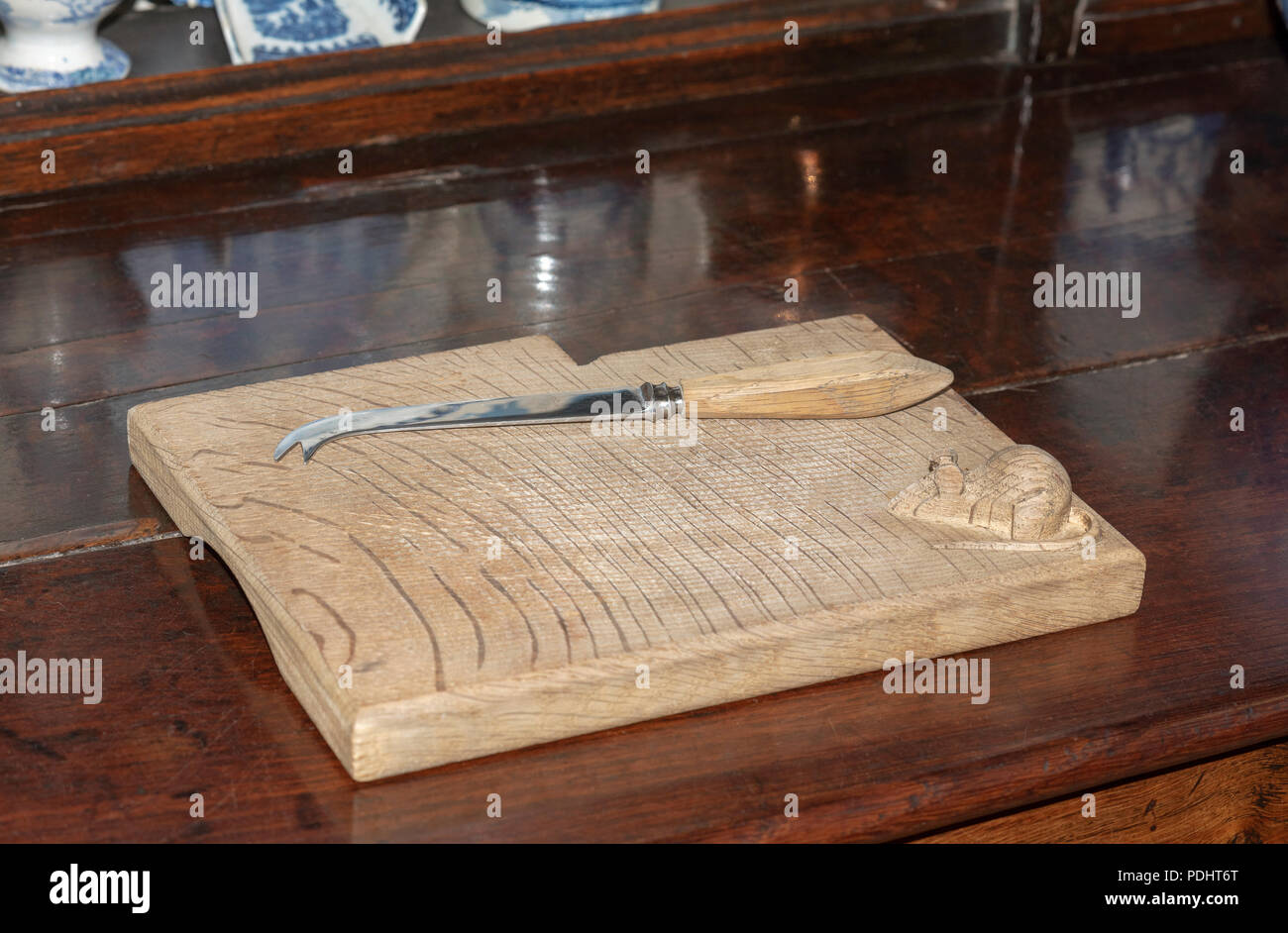 Antique cheese board and knife with a mouse carving in the righthand corner Stock Photo