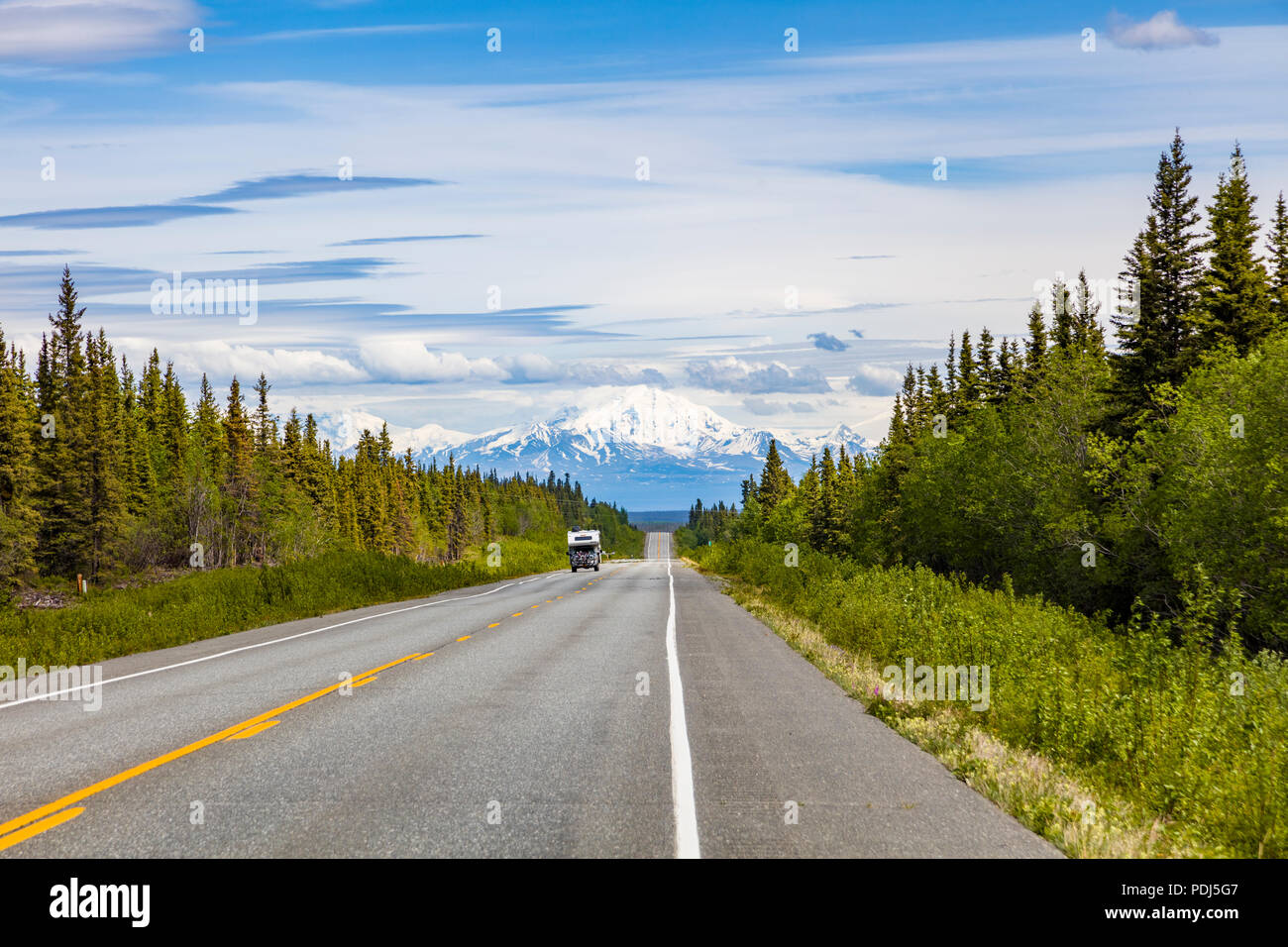 RV on straight smooth section of the Glenn Highway between Anchorage and Glennallen Alaska Stock Photo